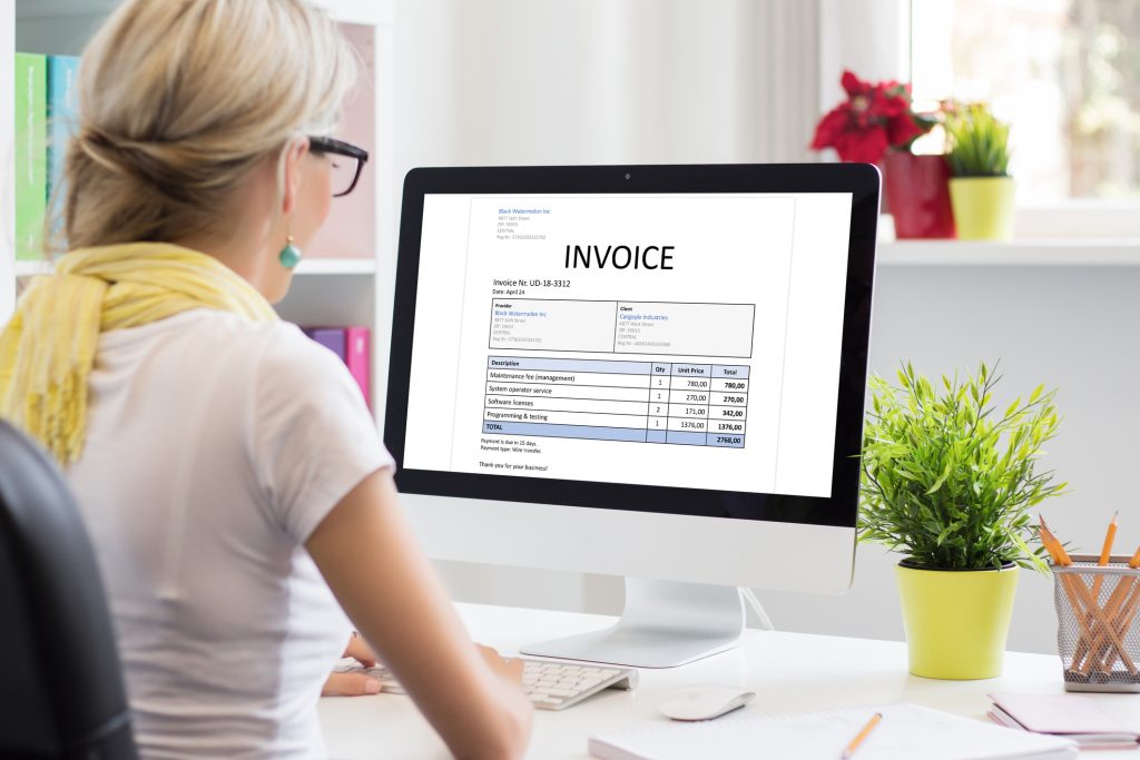 Woman working on computer to mail invoices