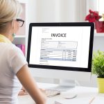 Woman working on computer to mail invoices